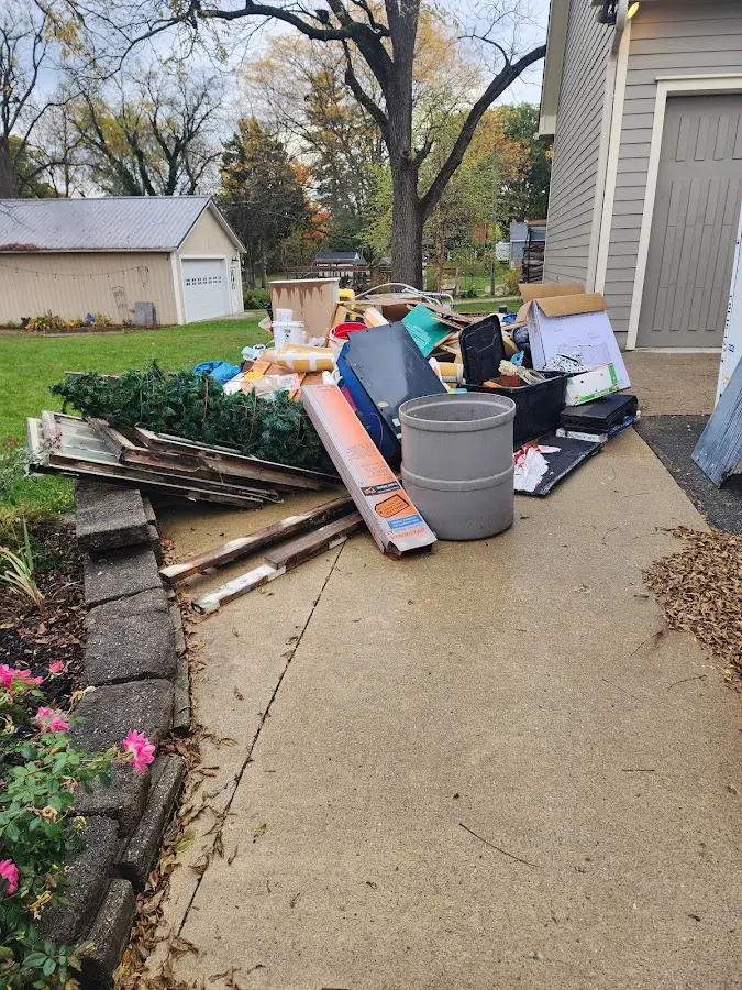 Dumpster being loaded with debris for 12 Yard Dumpster Rental in Sealy